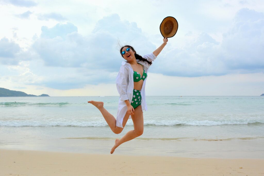 pexels-photo-237593-237593 Woman jumps joyfully on a Phuket beach in summer, embodying carefree vacation spirit.