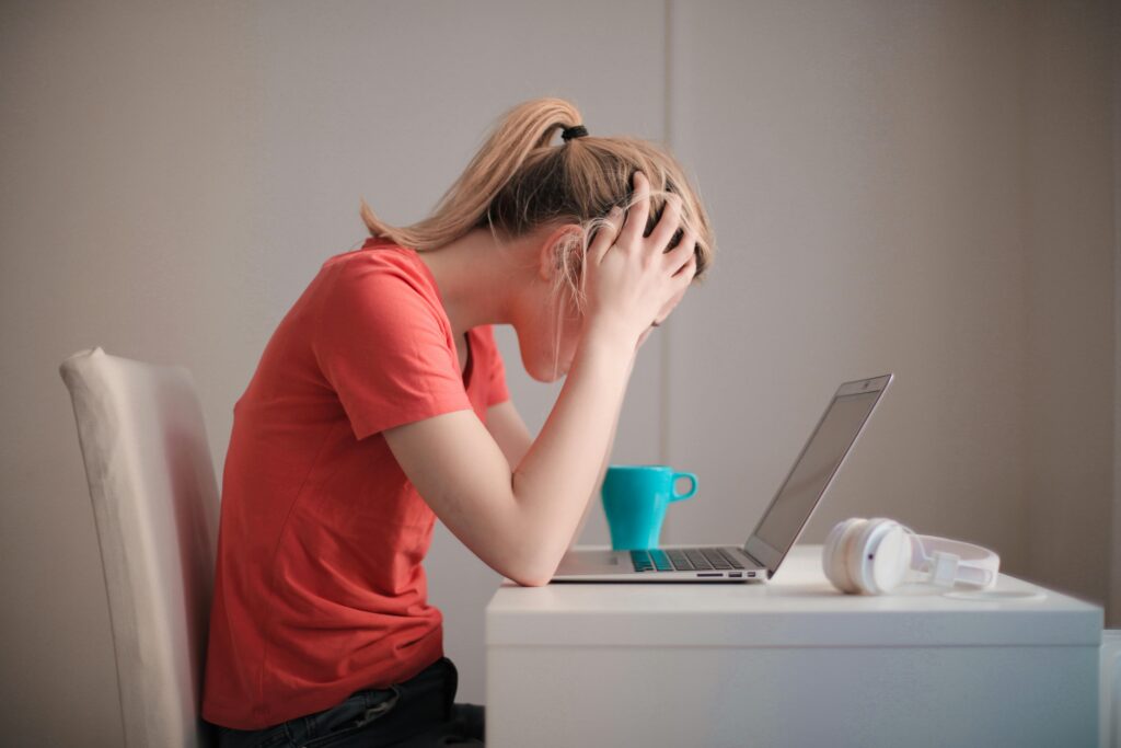 Young woman in a stressful state where she needs to contact the support.