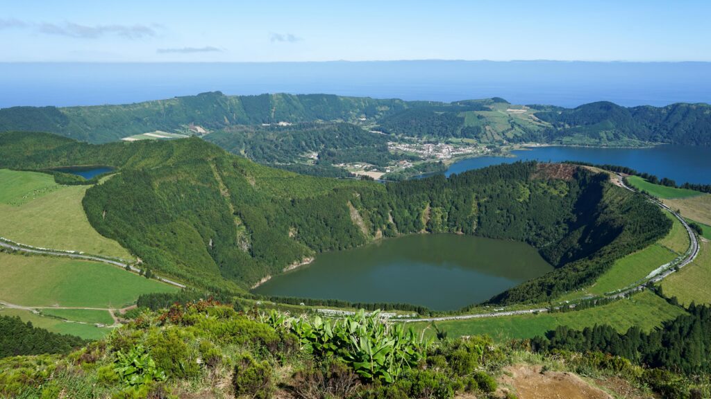 Sao Miguel Island (Azores). Sete Cidades Caldera, Lagoa de Santiago, Azores. A stunning aerial view of a lush green landscape featuring a crater lake surrounded by hills and valleys.