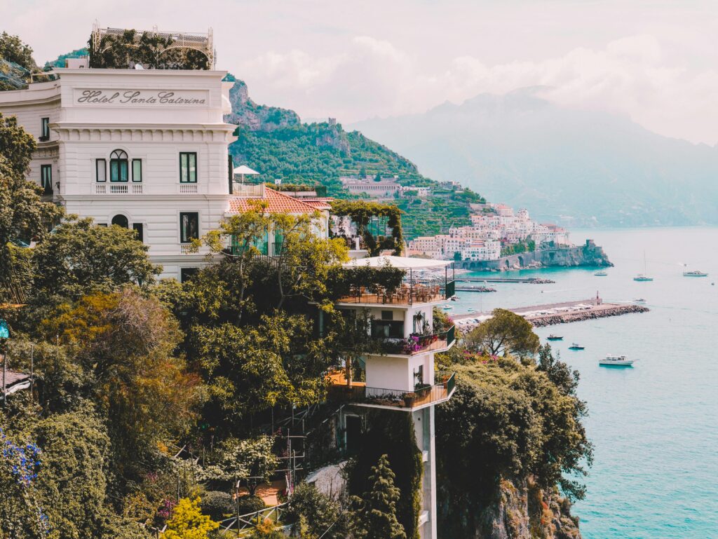 Stunning view of Amalfi Coast with cliffs, buildings, and boats. Perfect for travel and architecture lovers.
