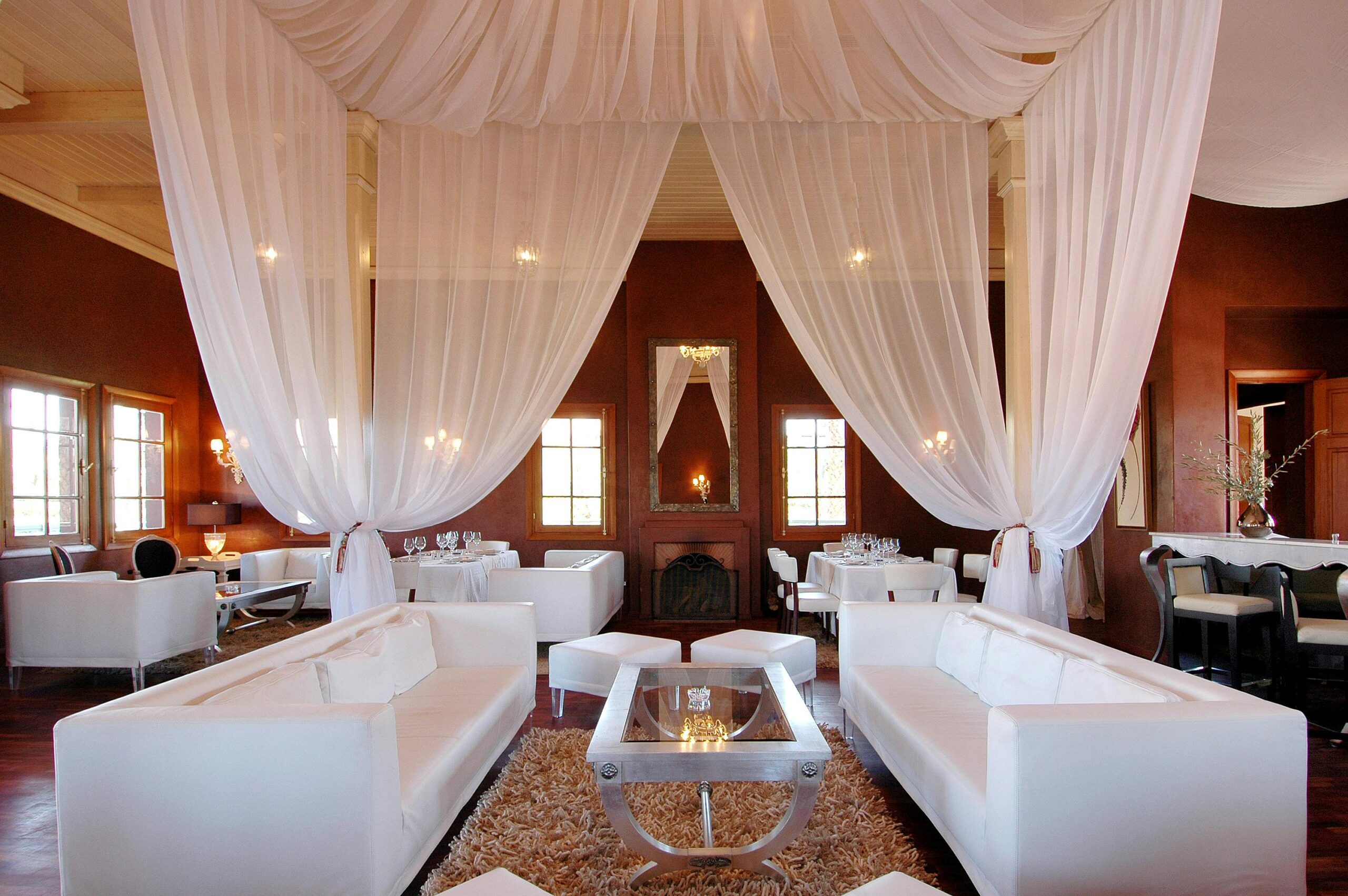 Elegant restaurant interior in - featuring luxurious draped ceilings and sophisticated furnishings.